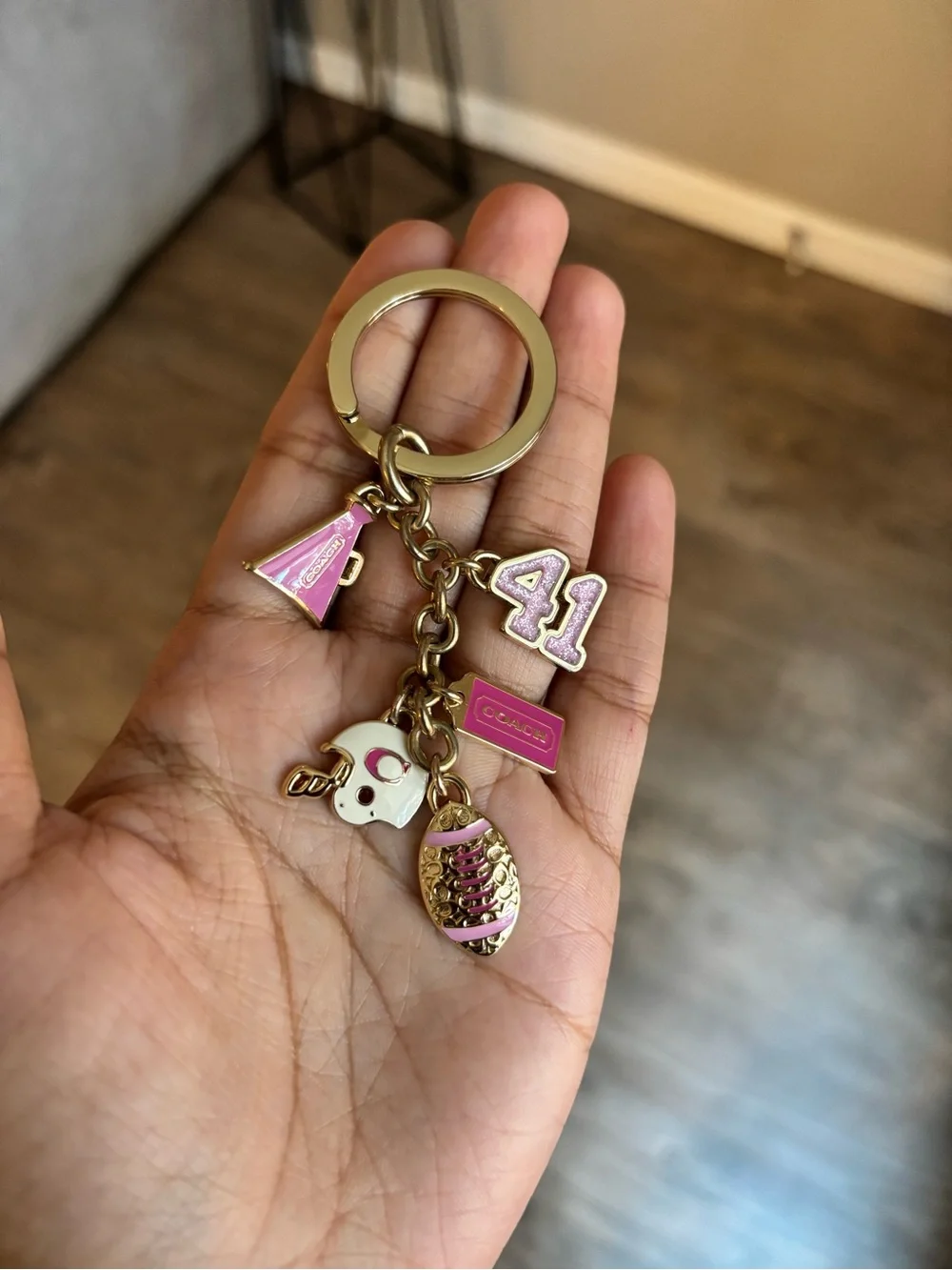 Coach Girly Football bag charm keychain in the champagne gold color